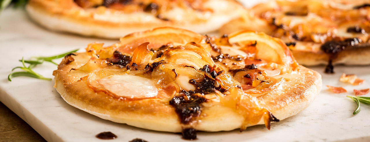 Pancetta and Caramelized Onion Pizzettes with Fig Drizzle